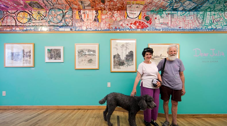 FILE - Julia Zagar, left, and her husband Isaiah Zagar pose for a photo with their dog Blue at the "Dear Julia" exhibit at Philadelphia's Magic Gardens May 26, 2016, in Philadelphia. (AP Photo/Matt Rourke, File)
