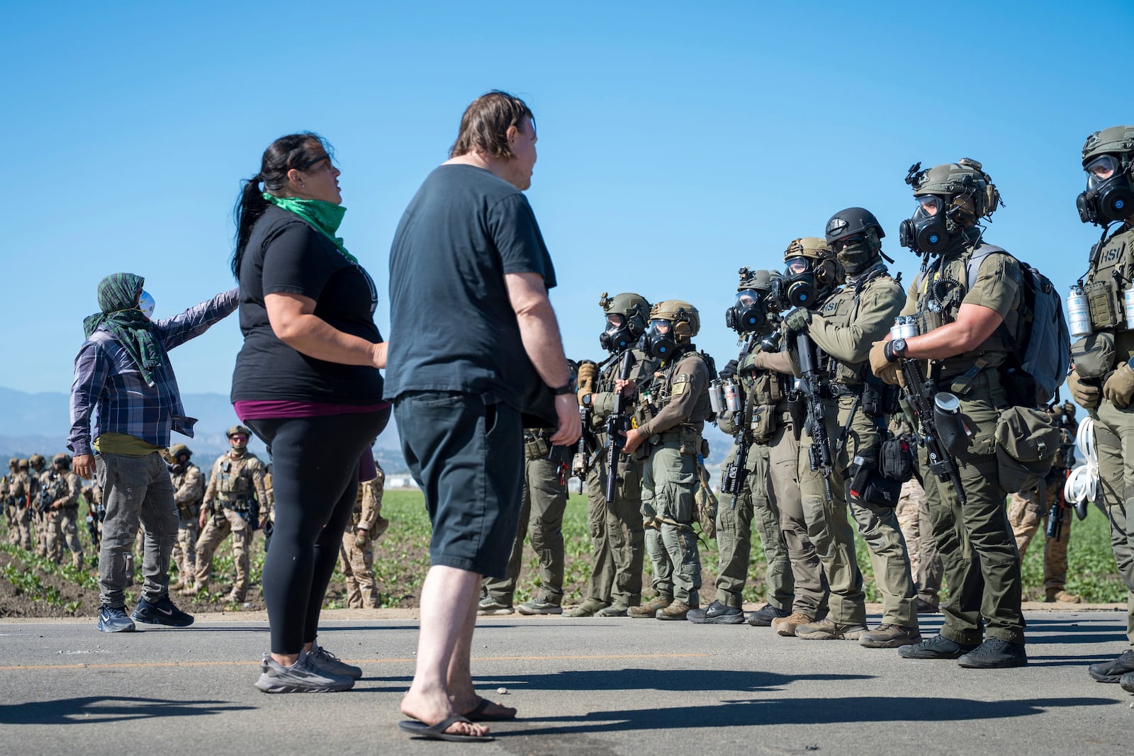 Protesters standoff against federal immigration agents during a raid in the agriculture area of Camarillo, Calif., Thursday, July 10, 2025. (AP Photo/Michael Owen Baker)