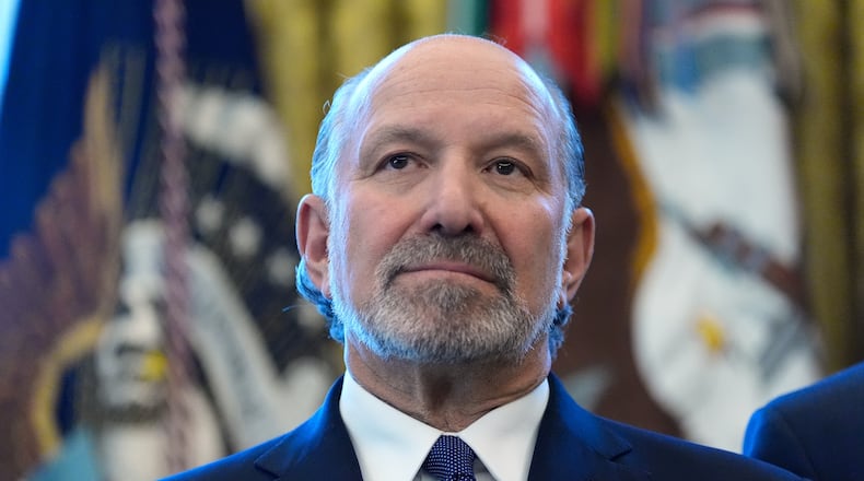 Commerce Secretary Howard Lutnick listens during an event with President Donald Trump in the Oval Office of the White House, Monday, Feb. 2, 2026, in Washington. (AP Photo/Alex Brandon)