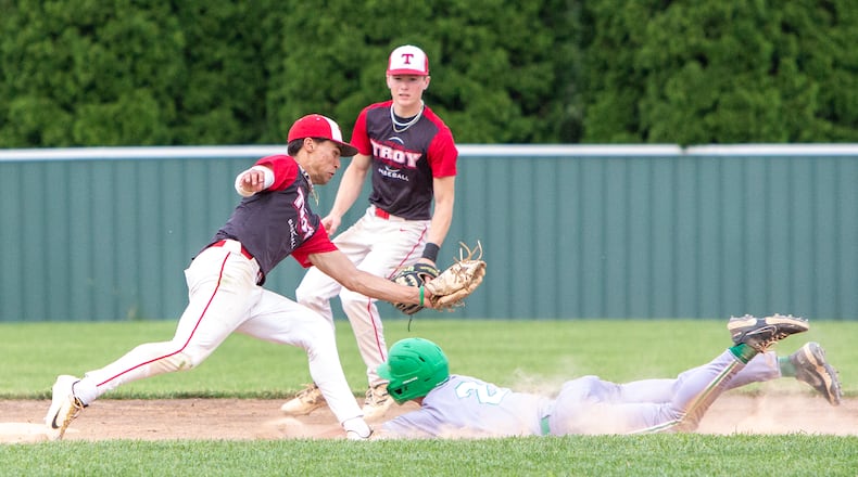 Troy shortstop Ryder Kirtley prepares to tag out a Mason base stealer during the seventh inning of Thursday's Division I district final won by Mason at Centerville High School.