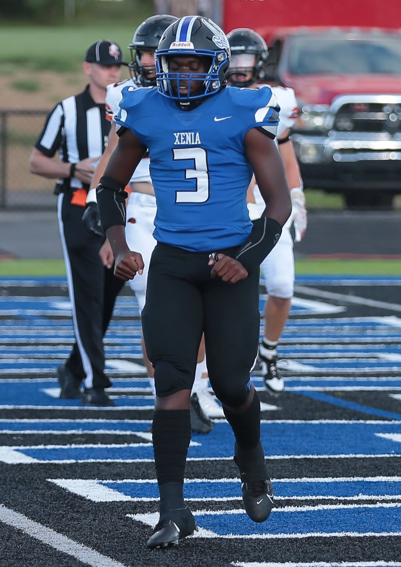 Xenia running back Deaunte White celebrates one of his three touchdowns on the night in the Buccaneers' season-opening 27-18 win over Beavercreek. Steve Black / Staff