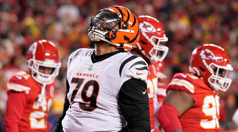 Cincinnati Bengals guard Jackson Carman (79) celebrates a touchdown by teammate running back Samaje Perine during the second half of the NFL AFC Championship playoff football game against the Kansas City Chiefs, Sunday, Jan. 29, 2023, in Kansas City, Mo. (AP Photo/Brynn Anderson)