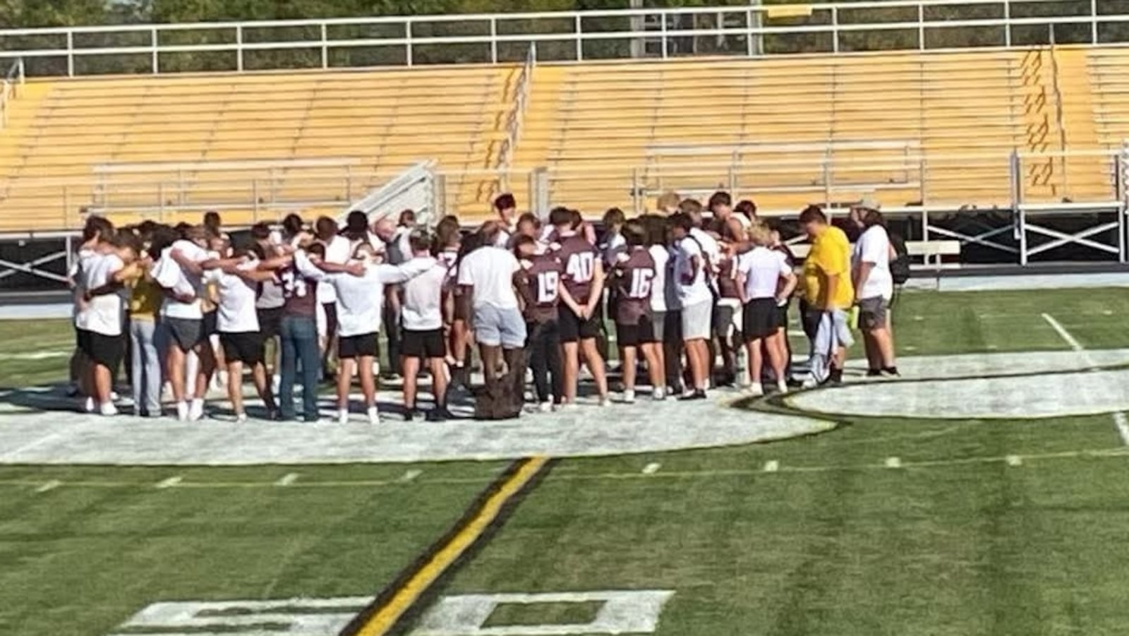 The Kenton Ridge football team praying with coaches on the Kenton Ridge High School field during the 2024 season. CONTRIBUTED