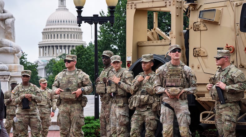 FILE - National Guard troops congregate at the entrance to Union Station in Washington, Aug. 20, 2025. (AP Photo/J. Scott Applewhite, FIle)