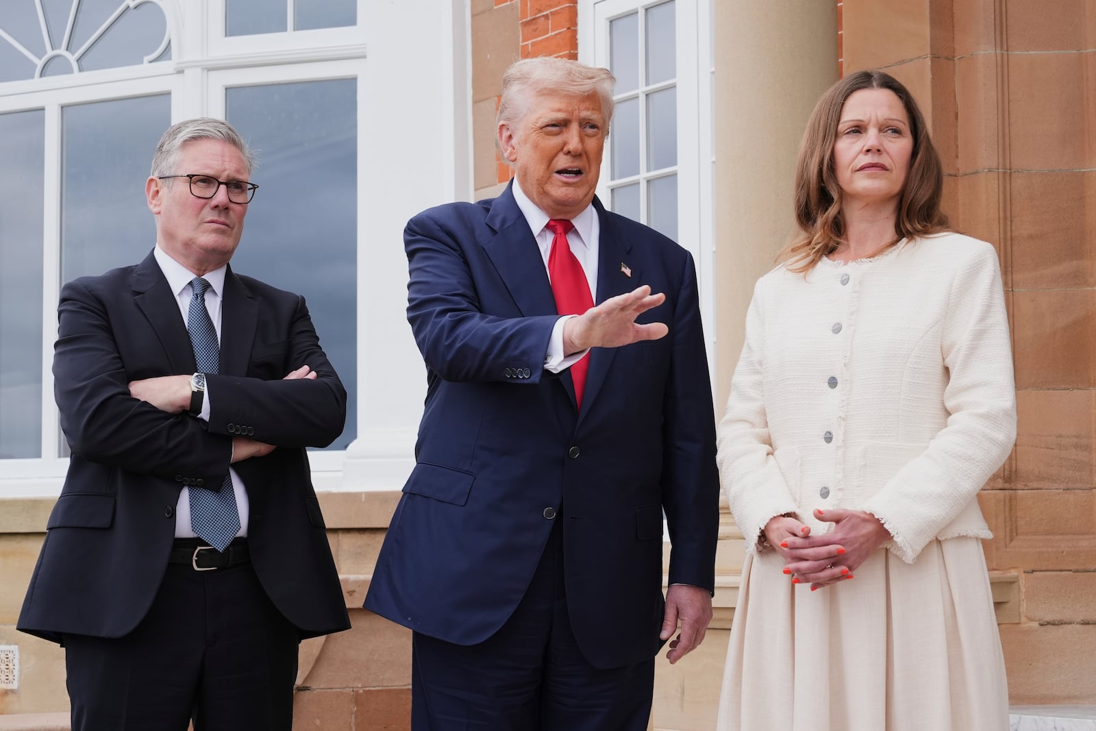 President Donald Trump, center, speaks with the media as he greets Britain's Prime Minister Keir Starmer, left, and his wife Victoria at the Trump Turnberry golf course in Turnberry, Scotland Monday, July 28, 2025. (AP Photo/Jacquelyn Martin)
