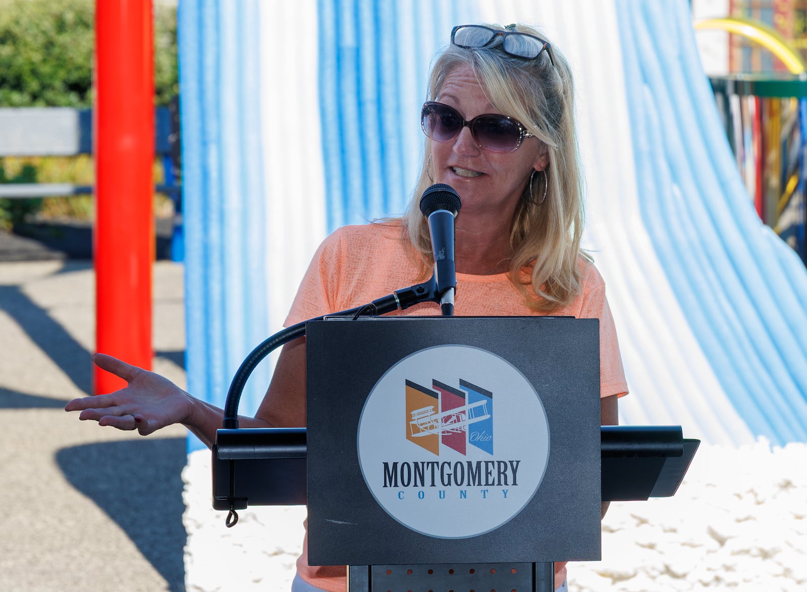 Casondra Hand, whose son is a resident at Stillwater Center, speaks during a dedication event on Friday, Aug. 8, for the center's playground, named The Cove. The playground is designed to be an inclusive and accessible space for Stillwater Center residents of all ages and abilities. BRYANT BILLING / STAFF