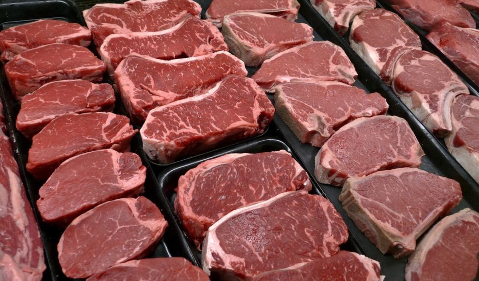 FILE - In this Jan. 18, 2010 file photo, steaks and other beef products are displayed for sale at a grocery store in McLean, Va. The meat industry is seeing red over the dietary guidelines. The World Health Organization’s cancer agency says Monday Oct.26, 2015 that processed meats such as ham and sausage can lead to colon and other cancers, and red meat is probably cancer-causing as well. (AP Photo/J. Scott Applewhite, File)