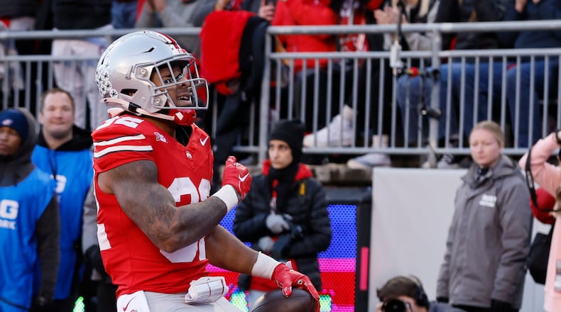 Ohio State running back TreVeyon Henderson celebrates after his touchdown against Minnesota during the first half of an NCAA college football game Saturday, Nov. 18, 2023, in Columbus, Ohio. (AP Photo/Jay LaPrete)
