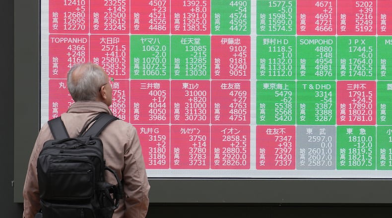 A person looks at an electronic stock board showing Japan's Nikkei index at a securities firm Tuesday, Nov. 25, 2025, in Tokyo. (AP Photo/Eugene Hoshiko)