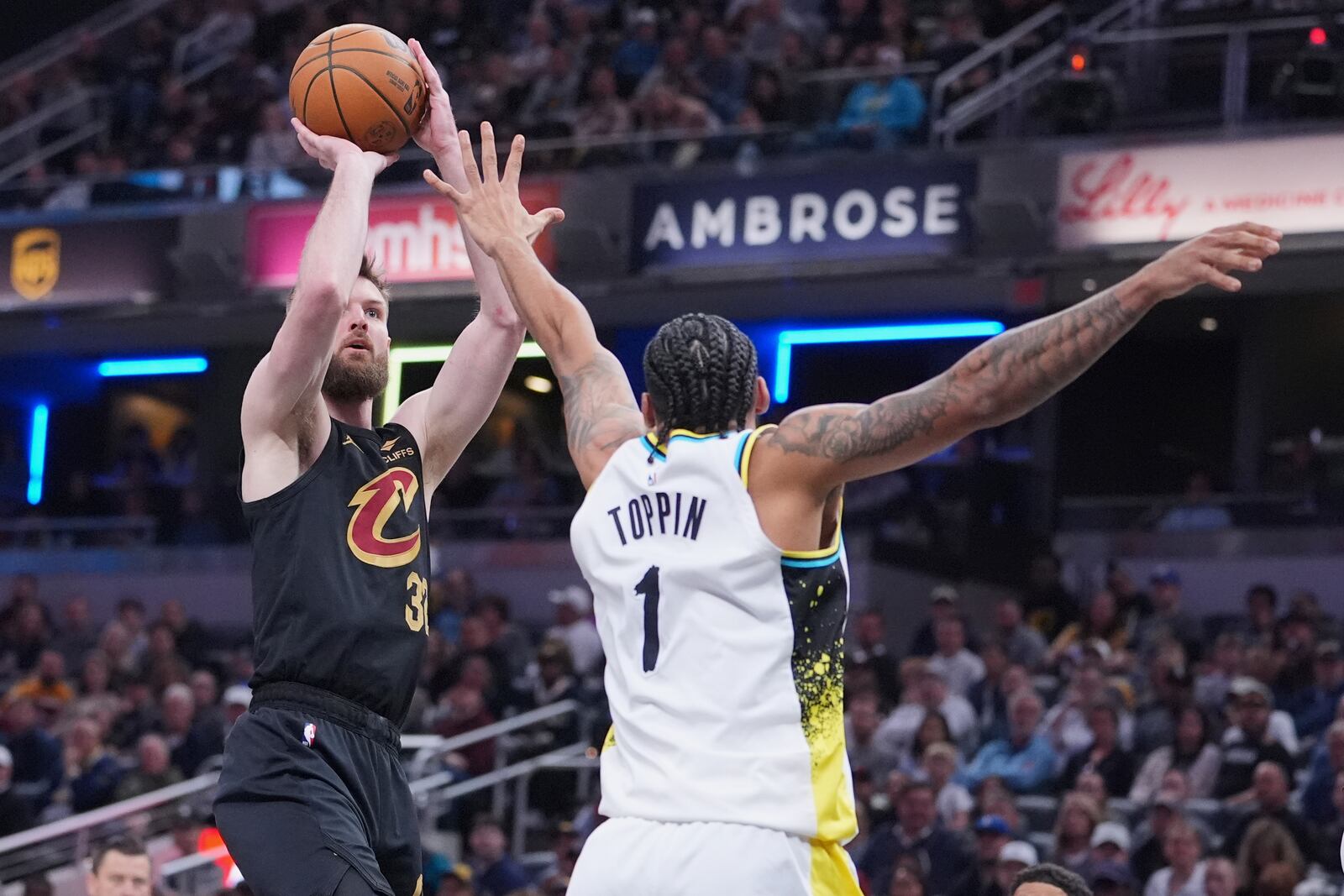 Cleveland Cavaliers forward Dean Wade (32) shoots over Indiana Pacers forward Obi Toppin (1) during the first half of an NBA basketball game in Indianapolis, Thursday, April 10, 2025. (AP Photo/Michael Conroy)