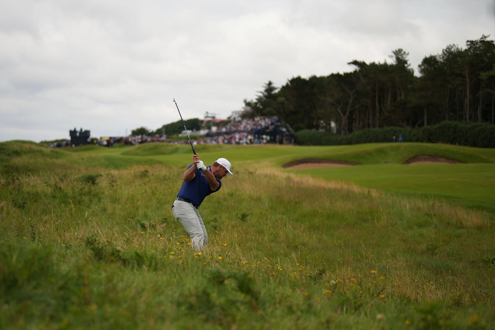 Bryson DeChambeau of the United States plays out of the rough on the 3rd hole during the first round of the British Open golf championship at the Royal Portrush Golf Club, Northern Ireland, Thursday, July 17, 2025. (AP Photo/Francisco Seco)