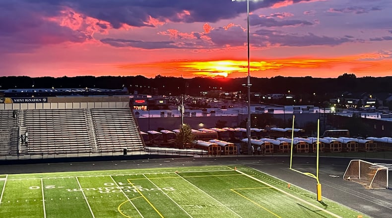 The sun sets as Springfield and Saint Ignatius wait out a lightning delay on Saturday, Aug. 20, 2022, at Byers Field in Parma. The game was cancelled. David Jablonski/Staff