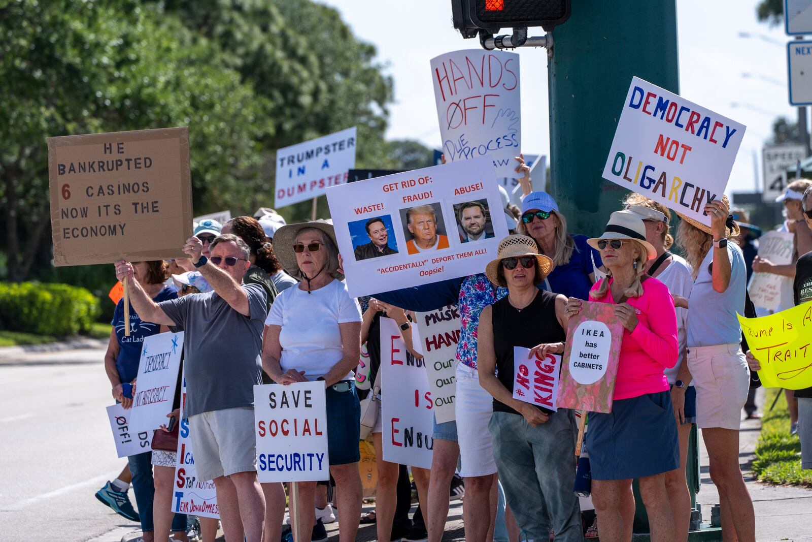 Activists protest President Donald Trump, who was a few miles away at his Trump National Golf Club, during a "Hands Off!" demonstration Saturday, April 5, 2025, in Palm Beach Gardens, Fla. (AP Photo/Alex Brandon)
