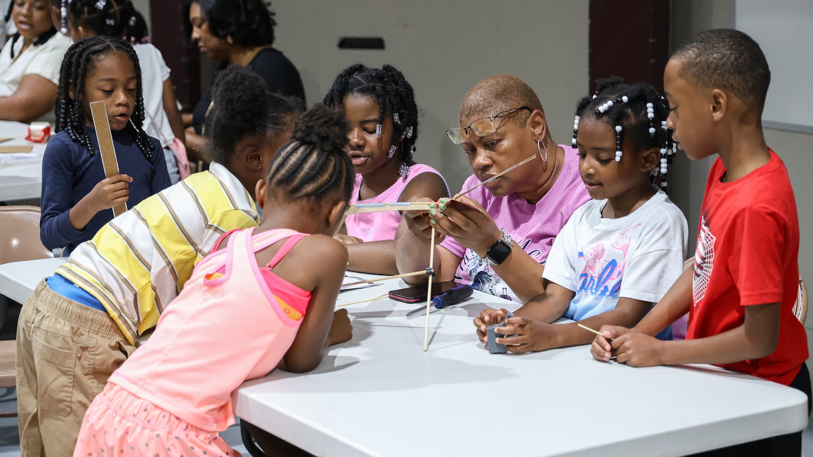 Students in Fail Me Not Tutoring work on a windmill project under the guidance of counselor Erica Wilson (center) on Wednesday, July 23 at the summer camp, which was held at Trotwood Preparatory and Fitness Academy property. BRYANT BILLING / STAFF