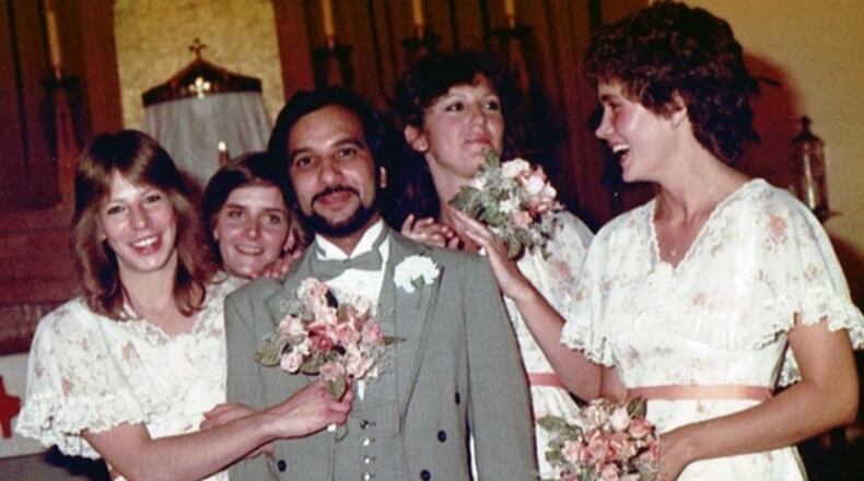 Holly (second from left) smiles as the bridesmaids tease the bemused groom.
