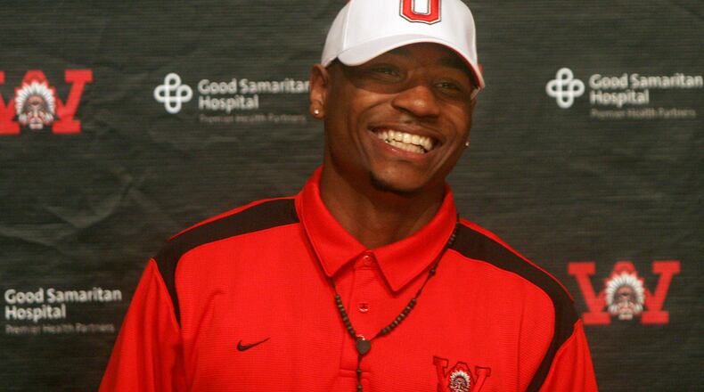 Braxton Miller, Wayne High School’s star quarterback, sports an Ohio State had at a press conference Thursday, June 3. Miller, who just completed his junior year, revealed his intention to join the Ohio State football team after he graduates. Staff photo by Jan Underwood