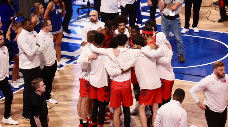 Dayton huddles before a game against Saint Louis on Friday, March 3, 2023, at Chaifetz Arena in St. Louis, Mo. David Jablonski/Staff