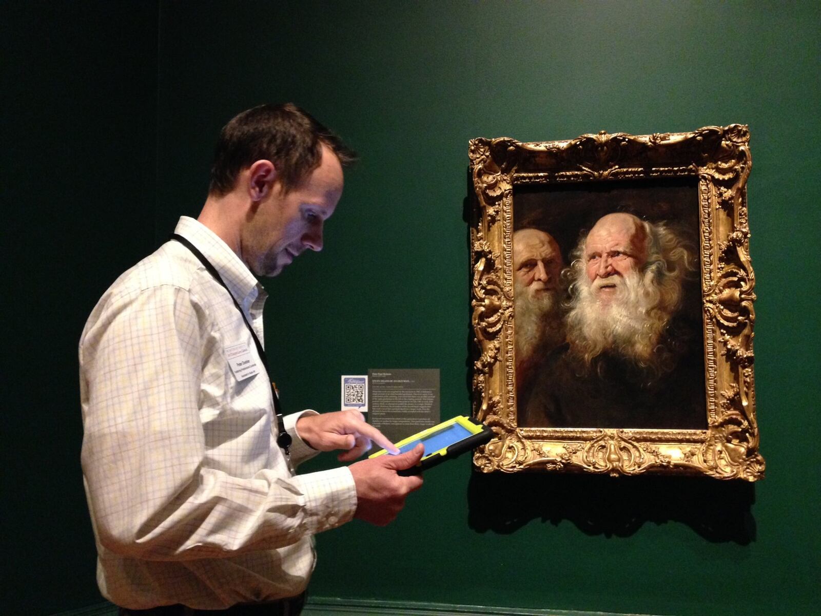The Dayton Art Institute’s Peter Doebler demonstrates “What is a Masterpiece?” Visitors can learn more about specific works of art through their mobile devices. MEREDITH MOSS/STAFF