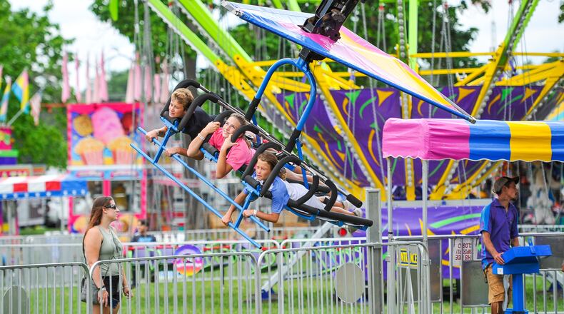Fair attendees take a ride at the Butler County Fair Monday, July 23 in Hamilton. NICK GRAHAM/STAFF