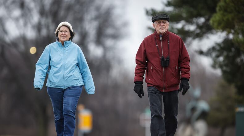 Marilyn Calondis and Joe Niebel, from West Carrollton, walk along the Great Miami River near Carillon Park for exercise and to keep an eye on the eagles that nest in the park. JIM NOELKER/STAFF
