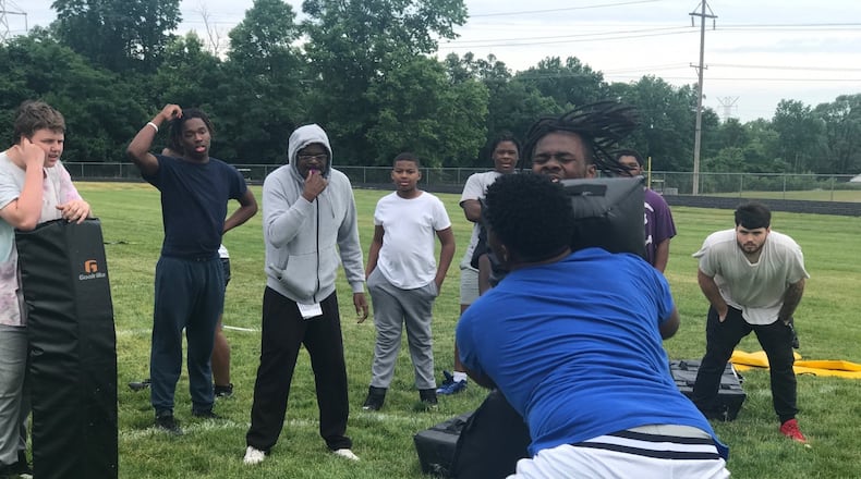 Coach Jackie Fails Jr, (gray hood) conducts drills at Thurgood Marshall High summer practice eariler this week. Tom Archdeacon/CONTRIBUTED