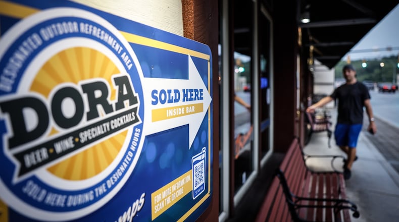 REVISED CUTLINE FOR 122822 mburg dora:    Miamisburg launched its Designated Outdoor Refreshment Area, or DORA, in July 2021 with hours of 4 to 9 p.m. Thursdays, 4 to 11 p.m. Fridays, noon to 11 p.m. Saturdays and 4 to 9 p.m. Sundays. Now liquor license holders are asking that the area's hours be extended to 11 a.m. to 11 p.m. Monday through Sunday. STAFF FILE PHOTO (ORIGINAL CAPTION : Miamisburg is working to form an oversight board for its newly formed DORA. Many businesses on Main St. are participating. Jim Noelker/Staff)