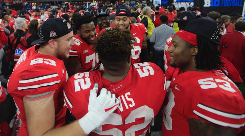 Ohio State players, including Wyatt Davis (52), celebrate a victory over Northwestern in the Big Ten Championship on Saturday, Dec. 1, 2018, at Lucas Oil Stadium in Indianapolis. David Jablonski/Staff David Jablonski/Staff