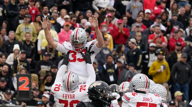Ohio State quarterback Devin Brown (33) celebrates a touchdown with Josh Fryar (70) during the first half of an NCAA college football game against Purdue, Saturday, Oct. 14, 2023, in West Lafayette, Ind. (AP Photo/Darron Cummings)
