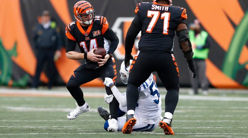 Cincinnati Bengals quarterback Andy Dalton (14) is sacked by Indianapolis Colts linebacker Tarell Basham (58) in the second half of an NFL football game, Sunday, Oct. 29, 2017, in Cincinnati. (AP Photo/Gary Landers)