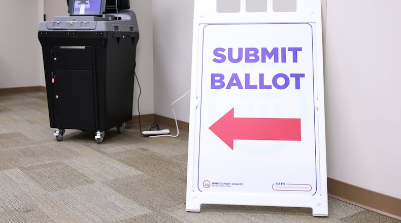 A sign pointing to a ballot scanning machine at Montgomery County Board of Elections on Tuesday, Oct. 7. BRYANT BILLING / STAFF