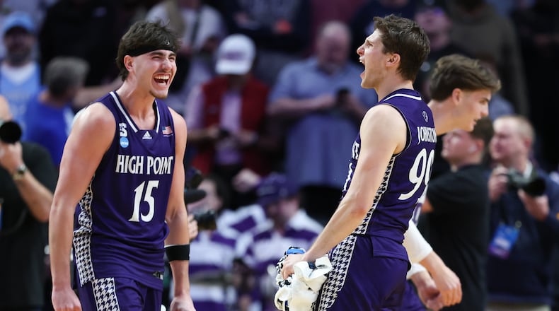 High Point forward Braden Hausen (15) celebrates with guard Chase Johnston, right, after the first round of the NCAA college basketball tournament against Wisconsin, Thursday, March 19, 2026, in Portland, Ore. (AP Photo/Amanda Loman)