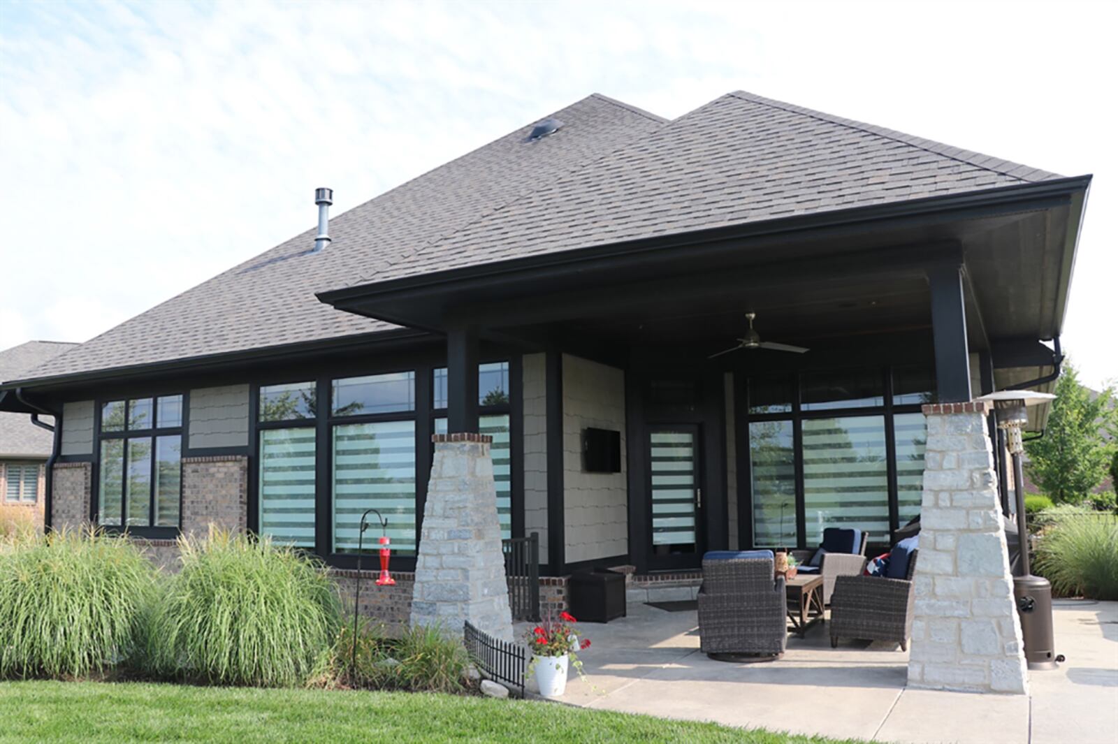 Accessible from the great room, the covered porch has a sun patio extension of stamped concrete. The porch is wired for a hot tub and is plumbed for a natural gas grill. There are built-in speakers. The back yard is fenced, and the yard has a sprinkler system. CONTRIBUTED PHOTO BY KATHY TYLER