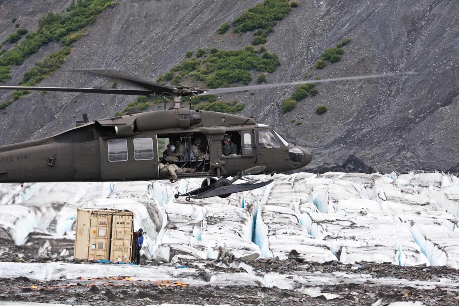 A UH-60 Blackhawk helicopter from the Alaska Army National Guard prepares to drop off members of the 3rd Aircraft Maintenance Squadron's Crash Recover team on Colony Glacier, Alaska July 10, 2012. The recovery team responded to a sighting by the National Guard that appeared to be an aircraft wreckage. (US Army photo/Staff Sgt. Brehl Garza)