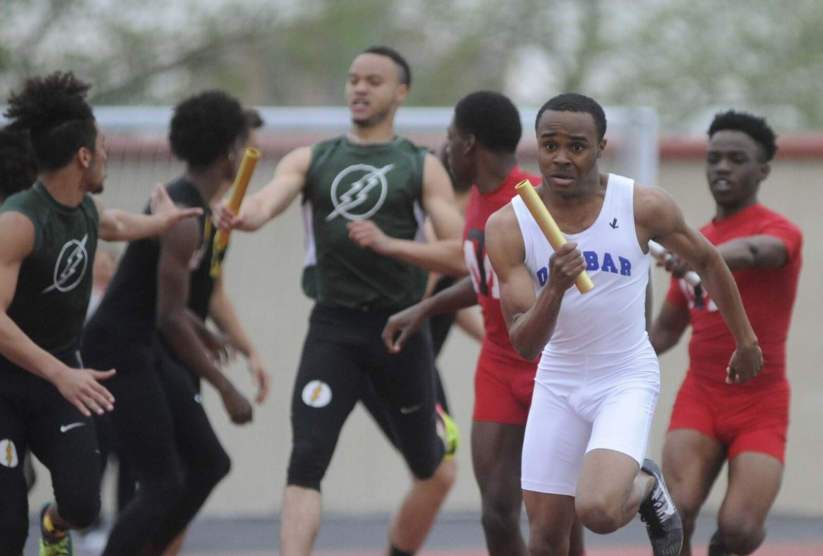 Dunbar’s Marquis Evans (right, front) takes the lead in the boys Swedish medley relay during the 67th Dayton Edwin C. Moses Relays at Welcome Stadium on Friday, April 21, 2017. MARC PENDLETON / STAFF