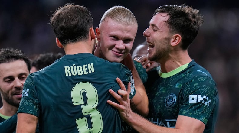 Manchester City's Erling Haaland, center, celebrates with teammates after scoring their side's second goal during a Champions League opening phase soccer match between Real Madrid and Manchester City, in Madrid, Spain, Wednesday, Dec. 10, 2025. (AP Photo/Manu Fernandez)