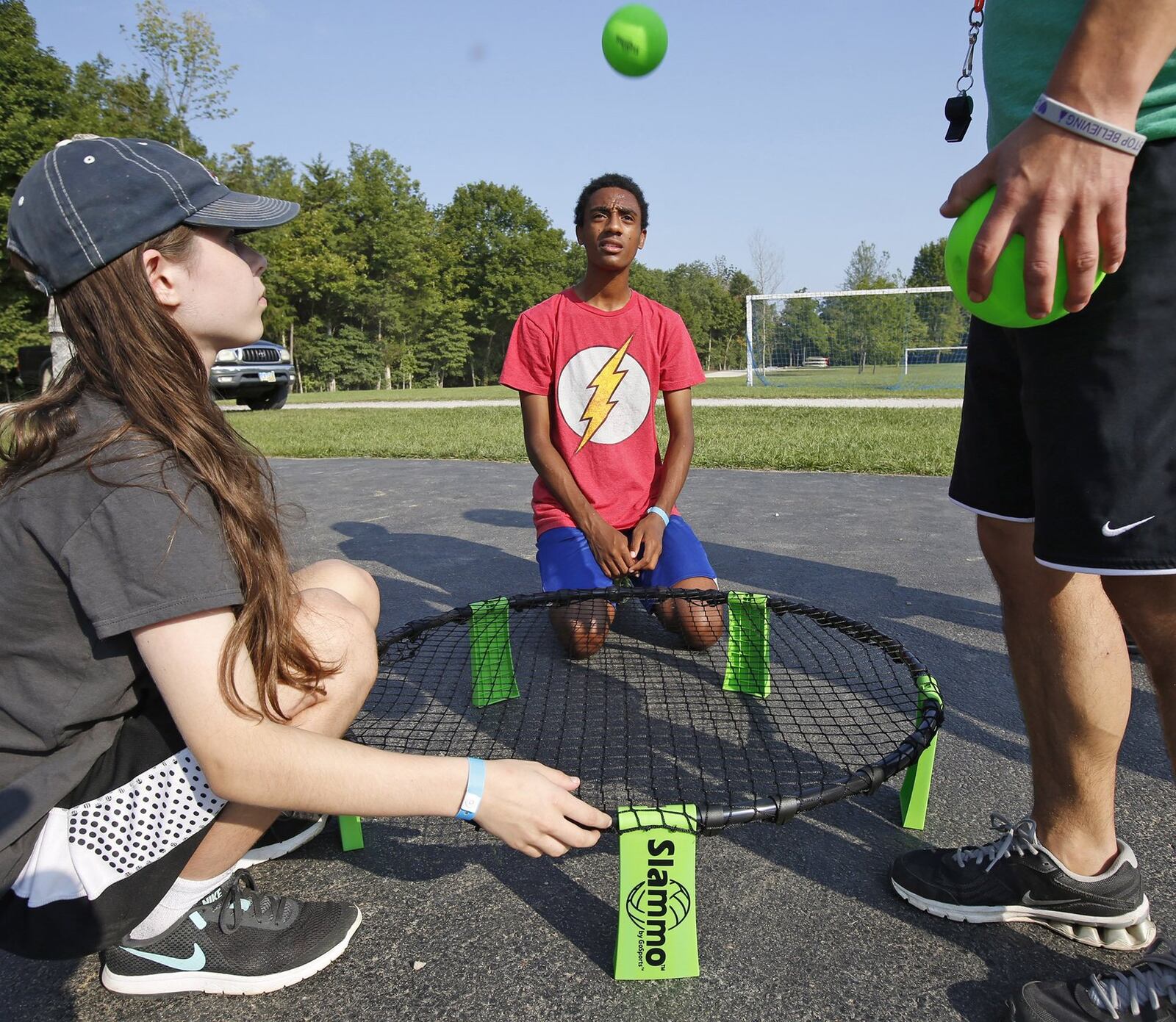 Bother and sister Danica and Abi test a Slammo ball net at Camp Sunrise. TY GREENLEES / STAFF