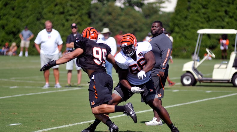 Cincinnati Bengals rookie defensive end Jordan Willis (99) goes against offensive lineman Trey Hopkins in a one-on-one blocking drill Sunday in the first training camp practice in shoulder pads. JAY MORRISON/STAFF
