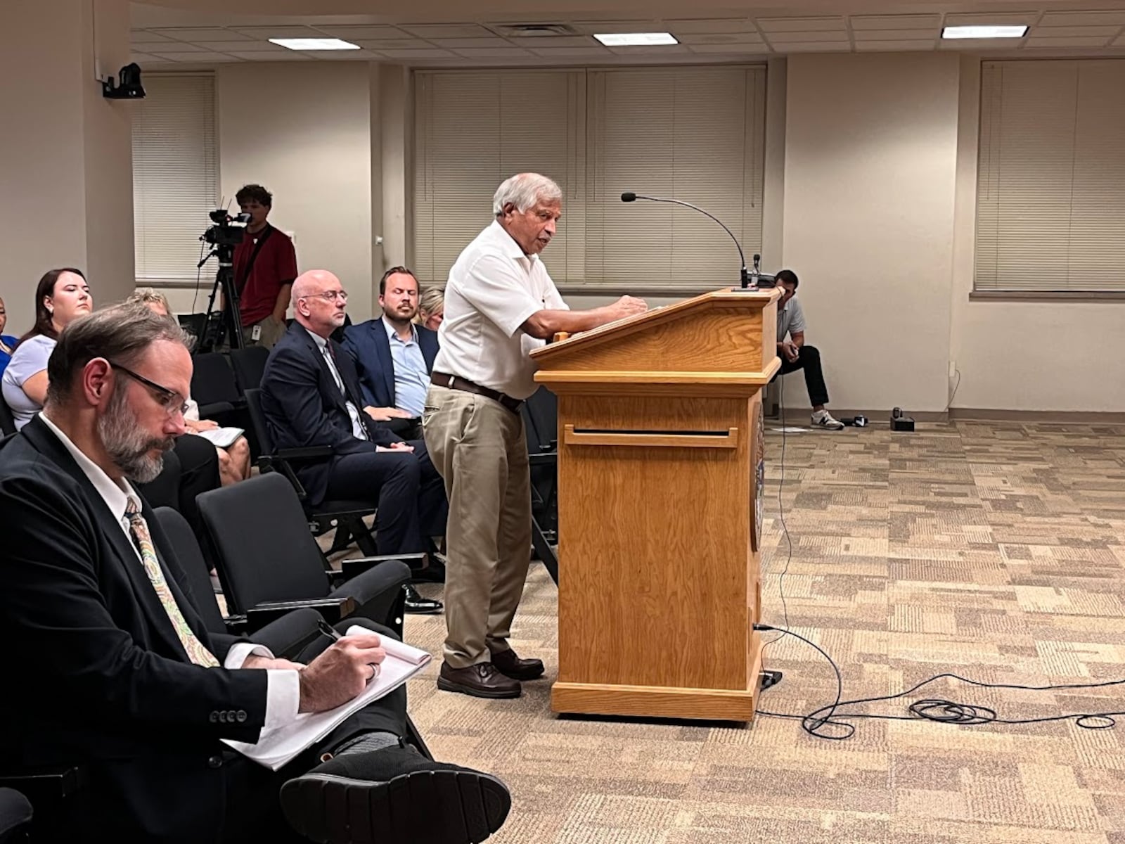 Sham Reddy, a Dayton-area Realtor, speaks with representatives of the Public Utilities Commission of Ohio Thursday Aug. 14, 2025 at the Dayton Municipal Building. THOMAS GNAU/STAFF