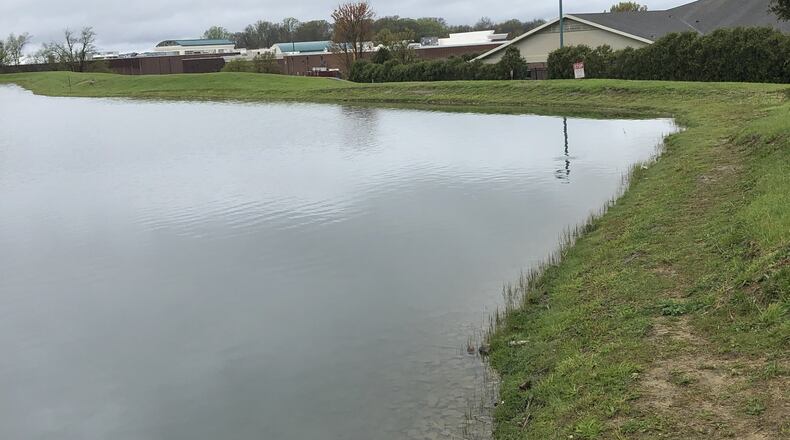 Settlers Walk homeowners and the owners of the retail development of the Springboro planned community continue to battle in court over what should be done and who is responsible for action on the Remick Lake dam ordered by the state. LAWRENCE BUDD/STAFF