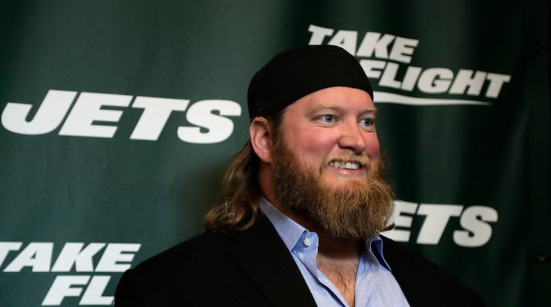 FILE - Former New York Jets center Nick Mangold poses for photographers on the green carpet ahead of an event unveiling the team's new NFL football uniforms, Thursday, April 4, 2019, in New York. The Jets will induct former cornerback Darrelle Revis, center Nick Mangold and left tackle D'Brickashaw Ferguson into the team's Ring of Honor during separate halftime ceremonies this season. The team announced Thursday, June 2, 2022, that Mangold will be the first honored with a ceremony during the Jets' game against Cincinnati on Sept. 25. Ferguson's induction will be Oct. 30 against New England, and Revis' will be Nov. 27 against Chicago.(AP Photo/Julio Cortez, File)