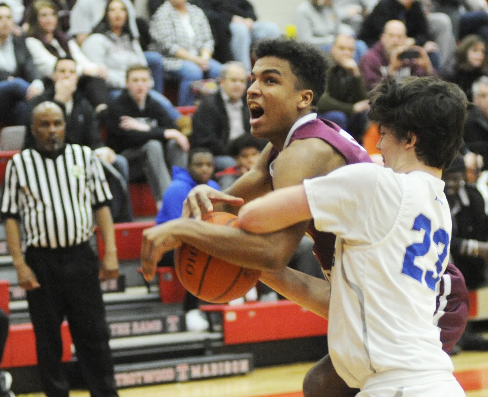 Colin Murphy of Miamisburg (right) ties up Milo White of Lebanon. Miamisburg defeated Lebanon 60-51 in a boys D-I sectional opener at Trotwood-Madison on Friday, Feb. 22, 2019. MARC PENDLETON / STAFF