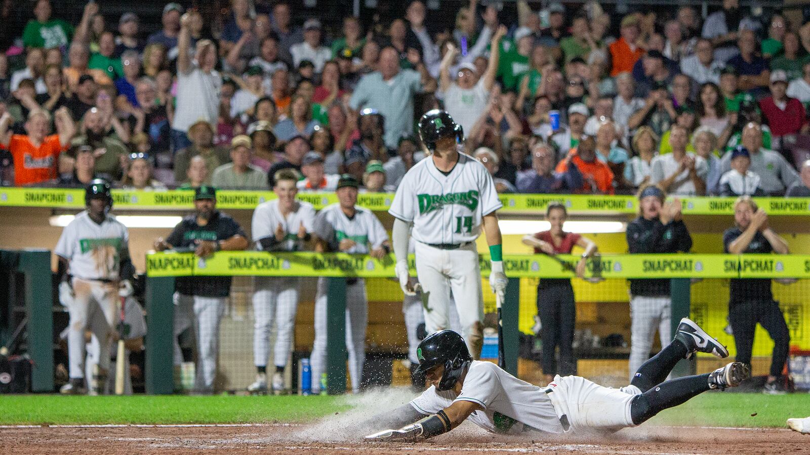 Leo Balcazar scores on a wild pitch in the sixth inning to give the Dragons a 2-1 lead. However, Lake County rallied in the ninth to win 4-3 at Day Air Ballpark. Jeff Gilbert/CONTRIBUTED