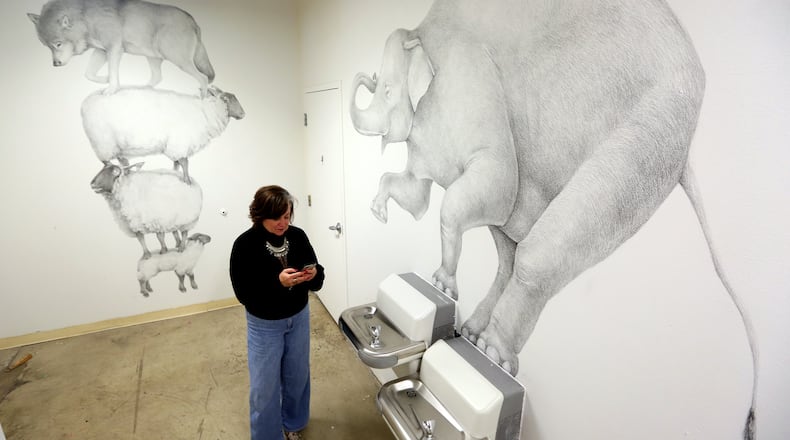 Large-scale drawings by artist Andrew Dailey, "Counting Sheep" and " Bloated Elevation" are on display in the Fountain Gallery, a secluded area at the back the The Contemporary Dayton. The art work will be on display until Dec. 21. LISA POWELL / STAFF