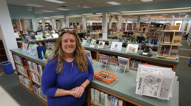Nicole Baker, director of the St. Paris Public Library, says the library has become an important part of the community. The St. Paris Public Library celebrated its 85th anniversary on Friday. BILL LACKEY / STAFF