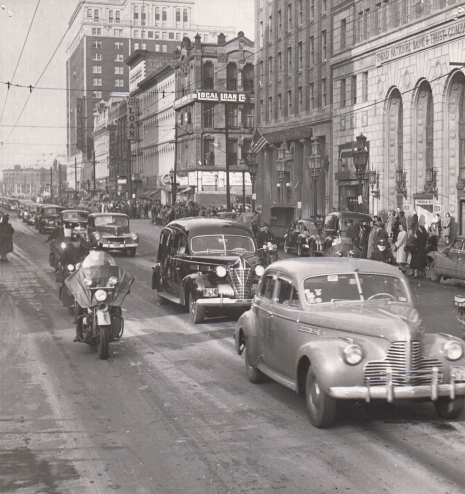 With motorcycle escort a portion of funeral procession moves slowly down Main St., en route to Woodland Cemetery. Hundreds of Daytonians lined both sides of Main St., to view the procession. DAYTON DAILY NEWS ARCHIVE