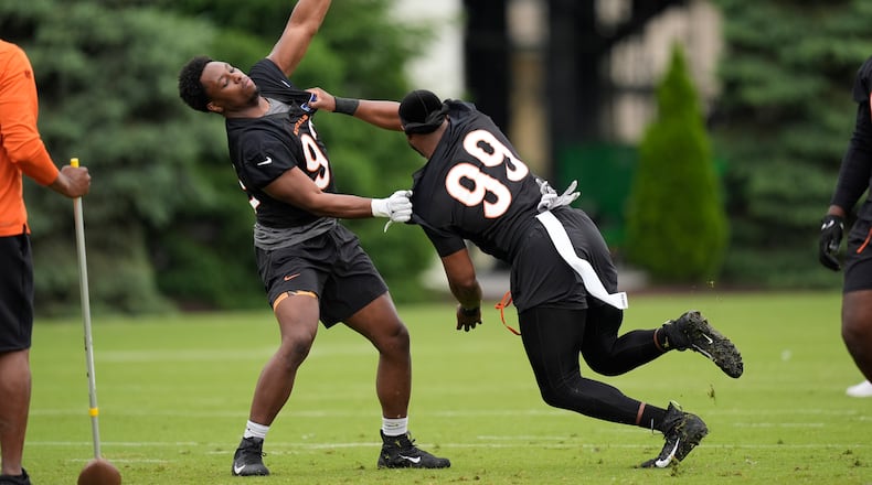 Cincinnati Bengals defensive ends Jeff Gunter (93) and Myles Murphy (99) work drills during the NFL football team's practice on Tuesday, May 14, 2024, in Cincinnati. (AP Photo/Carolyn Kaster)