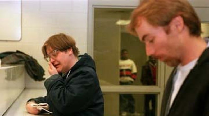 Jenny Wilcox weeps as she and Robert Aldridge are processed out of the prison system at the Montgomery County Jail on March 8, 1996. Dayton Daily News file photo