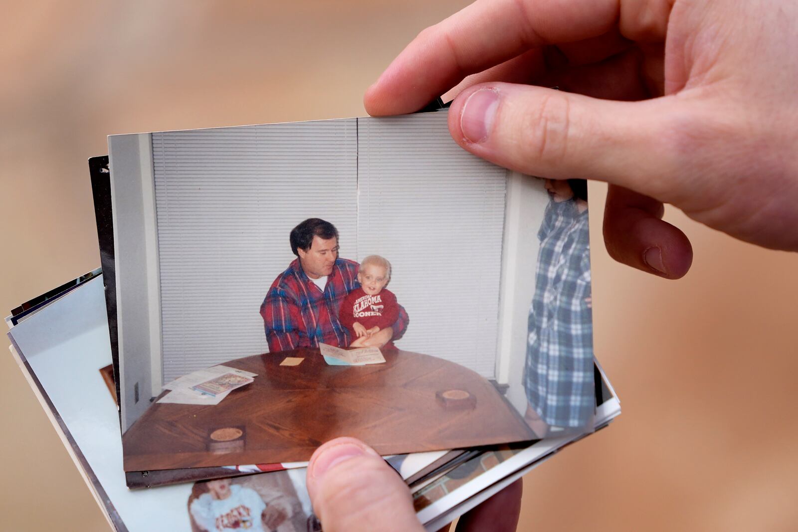 Austin Allen shows a photo of himself with his deceased father, Ted Allen, during an interview in Oklahoma City on March 12, 2025. Austin was 4 years old when his father died in the bombing of the Alfred P. Murrah Federal Building. (AP Photo/LM Otero)