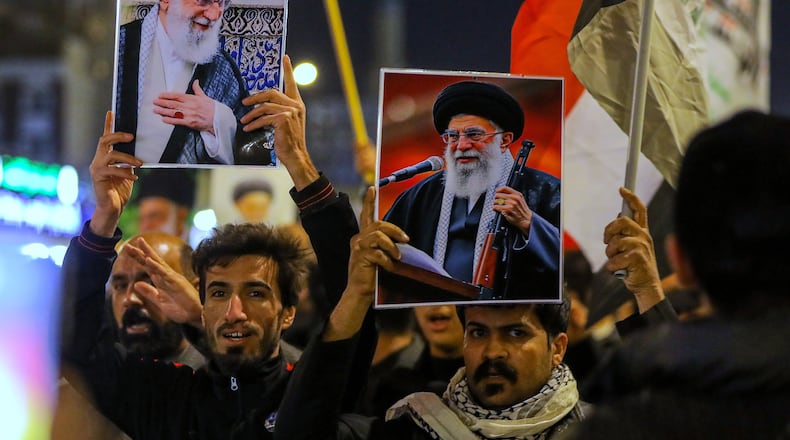 Iraqi Shiites hold pictures of Iranian Supreme Leader Ayatollah Ali Khamenei, who was killed by a U.S. airstrike in Tehran, during a symbolic funeral, in Najaf, Iraq, Sunday, March 1, 2026. (AP Photo/Anmar Khalil)