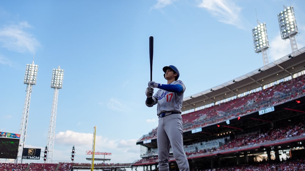 Los Angeles Dodgers' Shohei Ohtani stands near the on-deck circle before a baseball game against the Cincinnati Reds, Tuesday, July 29, 2025, in Cincinnati. (AP Photo/Carolyn Kaster)